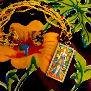 Two sided pendant hanging on necklace